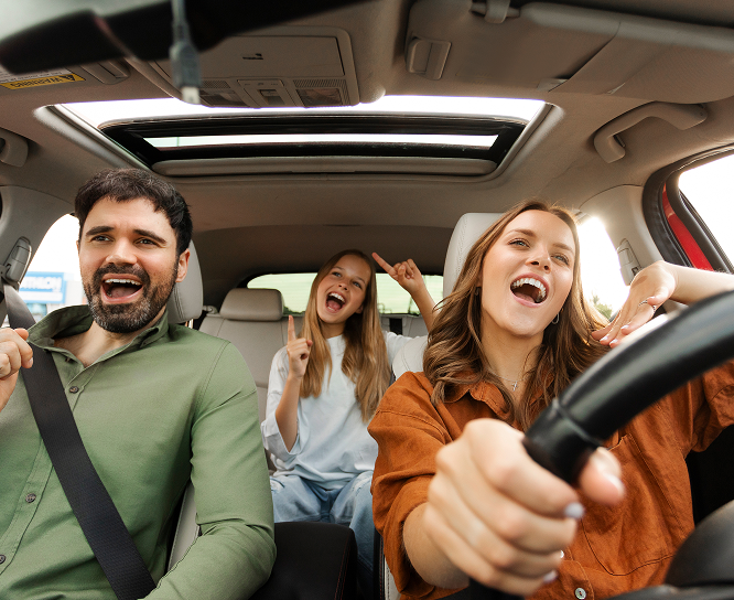 Happy people in car needing roadside assistance